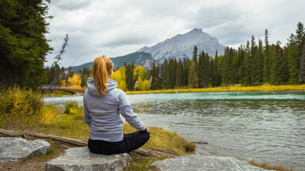 Woman meditating by the river